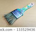Close-up of art tools lined up with well-used paintbrushes 30 133529436