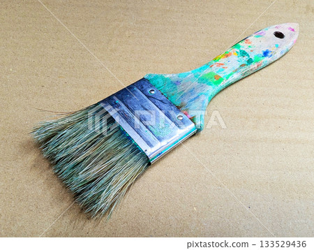 Close-up of art tools lined up with well-used paintbrushes 30 133529436