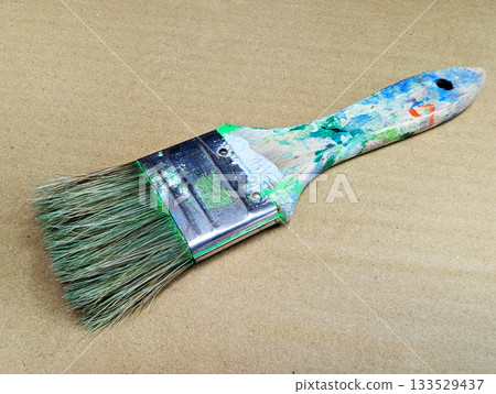 Close-up of art tools lined up with well-used paintbrushes 31 133529437