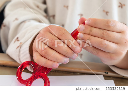 Child having fun with an authentic leisure activity, fine motor skills development Child having fun with an authentic leisure activity, fine motor skills development 133529819