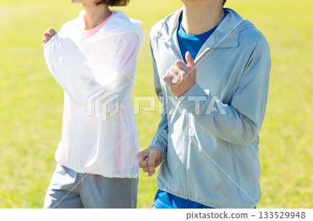 A middle-aged couple running outdoors A middle-aged couple running outdoors 133529948