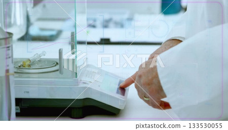 Operating scientist hands in lab coat entering data on analytical scale at lab, syringe, copy space Operating scientist hands in lab coat entering data on analytical scale at lab, syringe, copy space 133530055