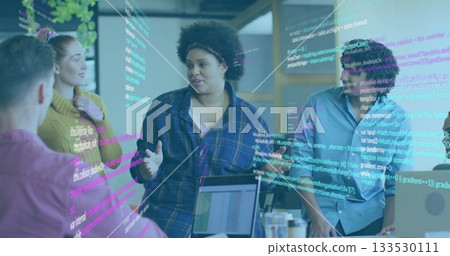 Gesturing African American woman leading discussion at office desk with laptops, mug, code overlay Gesturing African American woman leading discussion at office desk with laptops, mug, code overlay 133530111