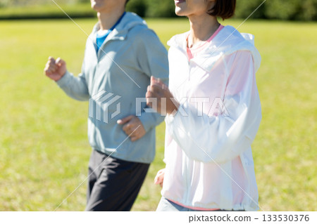 A middle-aged couple running outdoors A middle-aged couple running outdoors 133530376