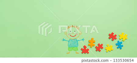 Autism awareness day concept with colorful puzzle pieces and child drawing 133530654