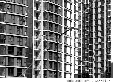 Architecture of modern highrise apartment buildings with geometric facade pattern. Urban residential Architecture of modern highrise apartment buildings with geometric facade pattern. Urban residential 133531107