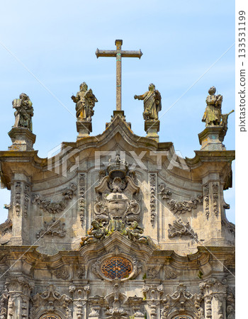 Carmo church in Porto Portugal with cross and statues of saints on baroque facade. Catholic landmark Carmo church in Porto Portugal with cross and statues of saints on baroque facade. Catholic landmark 133531199