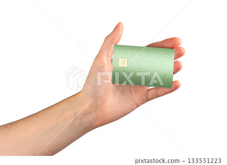 Close-up of a green credit card with chip, displayed in hand. Modern financial card 133531223