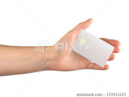 White textured bank card with chip in female hand. Minimalist debit or credit card isolated on white 133531225