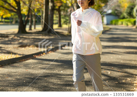Middle-aged woman running outdoors 133531669