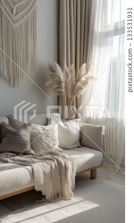 Sunlit bohemian living room corner with soft neutral textiles, pampas grass and cozy decor. this image conveys calm interior style, warm relaxation and serene home atmosphere 133531931