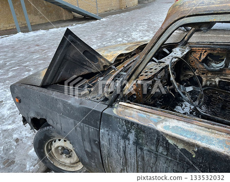 A burnt-out car displays severe damage after a recent fire event A burnt-out car displays severe damage after a recent fire event 133532032