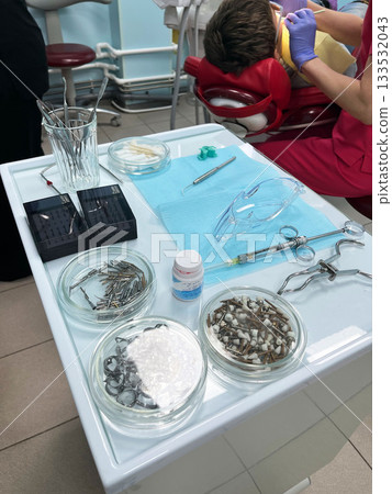 Dental tools and materials laid out for patient treatment in a clinic 133532043
