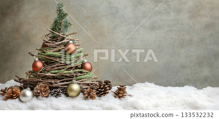 Creative Christmas tree with branches and ornaments on snow 133532232