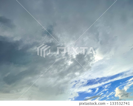 The blue sky beyond the spreading clouds The blue sky beyond the spreading clouds 133532741
