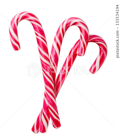 Three Christmas candy canes cut out on a white. Isolated Three Christmas candy canes cut out on a white. Isolated 133534194