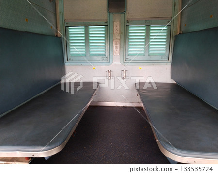 Empty seats, windows and berths inside a second class sleeper compartment in a train run by the Indian Railways. Empty seats, windows and berths inside a second class sleeper compartment in a train run by the Indian Railways. 133535724