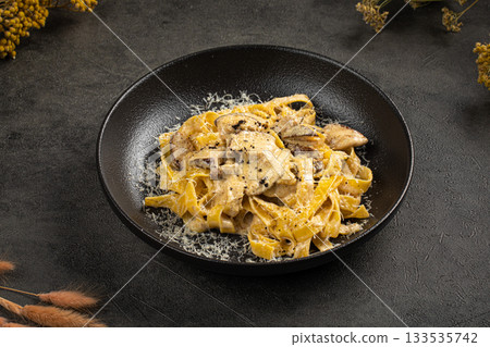 Creamy tagliatelle pasta with mushrooms Creamy tagliatelle pasta with mushrooms 133535742