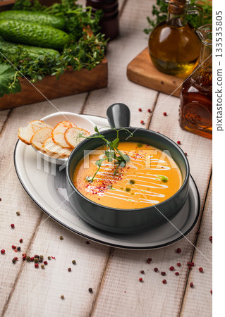 Creamy pumpkin soup with croutons garnish 133535805