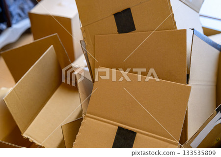 A room littered with opened cardboard boxes A room littered with opened cardboard boxes 133535809