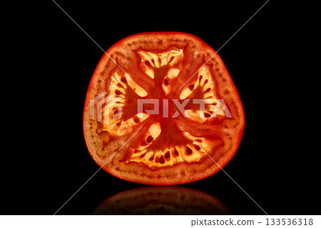 Slice tomatoes backlit isolated on a black background 133536318