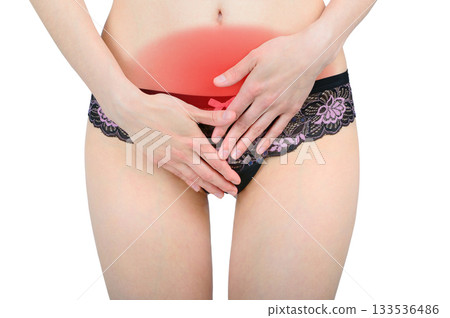 Woman's hands cover her stomach in pain 133536486