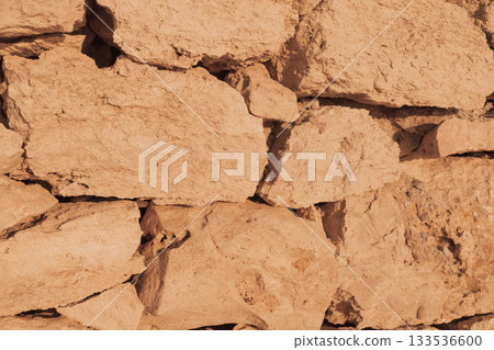 Old natural stone masonry without mortar between the stones, natural background 133536600