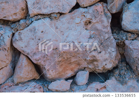 Old natural stone masonry without mortar between the stones, natural background 133536655
