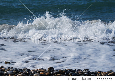 Waves crashing against the seashore with dramatic splashes 133536666