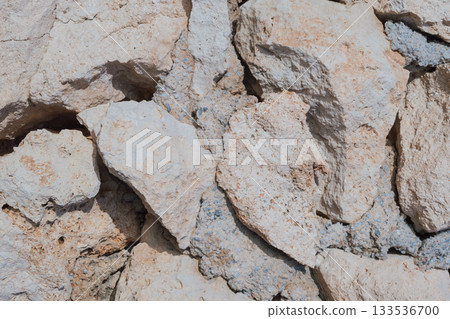 Old natural stone masonry without mortar between the stones, natural background Old natural stone masonry without mortar between the stones, natural background 133536700