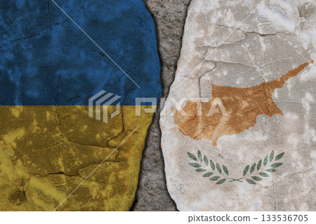 Symbolic split between Ukraine and Cyprus flags on cracked stone wall texture Symbolic split between Ukraine and Cyprus flags on cracked stone wall texture 133536705
