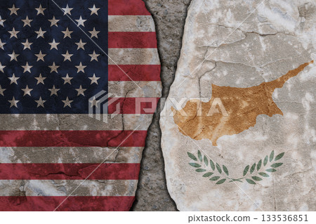 Symbolic split between USA and Cyprus flags on cracked stone wall texture 133536851
