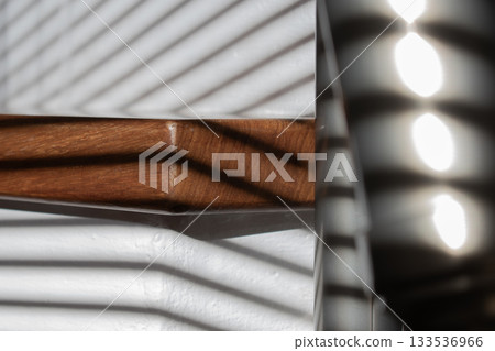 Wooden steps bathed in sunlight through blinds Wooden steps bathed in sunlight through blinds 133536966