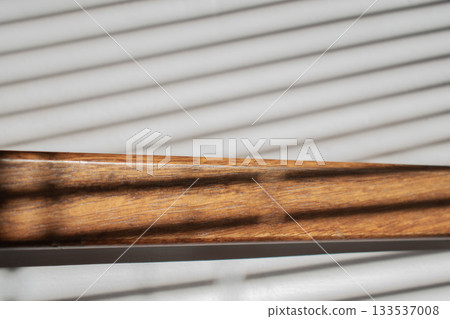 Wooden steps bathed in sunlight through blinds Wooden steps bathed in sunlight through blinds 133537008