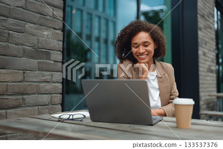 dedicated student absorbing knowledge outside surrounded by modern campus architecture and study materials dedicated student absorbing knowledge outside surrounded by modern campus architecture and study materials 133537376