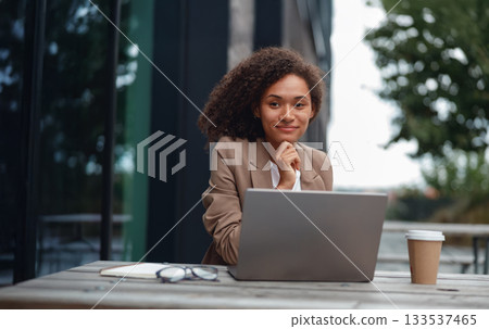 focused professional preparing for client presentation amidst city park and cafe environment focused professional preparing for client presentation amidst city park and cafe environment 133537465