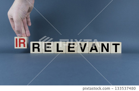 Cubes form the words Irrelevant or relevant. Concept of information and business 133537480