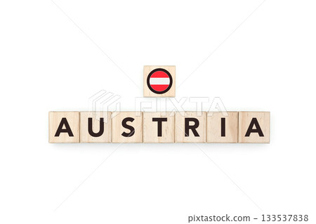 Wooden blocks bearing the name and flag of Austria. Austrian and European Culture, national identity, travel, and geography in a copy space design. 133537838