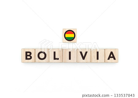 Wooden blocks bearing the name and flag of Bolivia. Bolivian and South American Culture, national identity, travel, and geography in a copy space design. Wooden blocks bearing the name and flag of Bolivia. Bolivian and South American Culture, national identity, travel, and geography in a copy space design. 133537843