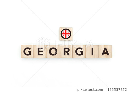 Wooden blocks bearing the name and flag of Georgia. Georgian and Asian Culture, national identity, travel, and geography in a copy space design. 133537852