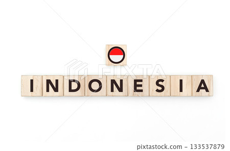Wooden blocks bearing the name and flag of Indonesia. Indonesian and Austral Culture, national identity, travel, and geography in a copy space design. 133537879