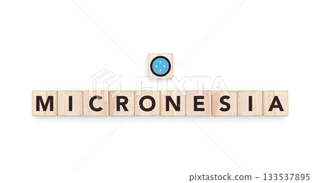 Wooden blocks bearing the name and flag of Federated States of Micronesia. Micronesian and Indonesian Culture, national identity, travel, and geography in a copy space design. Wooden blocks bearing the name and flag of Federated States of Micronesia. Micronesian and Indonesian Culture, national identity, travel, and geography in a copy space design. 133537895