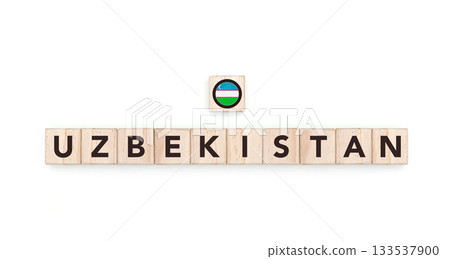Wooden blocks bearing the name and flag of Uzbekistan. Uzbek and Asian Culture, national identity, travel, and geography in a copy space design. Wooden blocks bearing the name and flag of Uzbekistan. Uzbek and Asian Culture, national identity, travel, and geography in a copy space design. 133537900