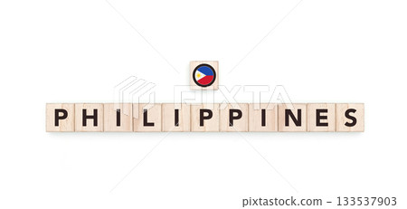 Wooden blocks bearing the name and flag of Philippines. Filipino and Asian Culture, national identity, travel, and geography in a copy space design. Wooden blocks bearing the name and flag of Philippines. Filipino and Asian Culture, national identity, travel, and geography in a copy space design. 133537903
