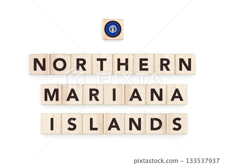 Wooden blocks bearing the name and flag of Northern Mariana Islands. Marianan and Polynesian Culture, national identity, travel, and geography in a copy space design. 133537937