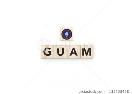 Wooden blocks bearing the name and flag of Guam. Guamanian and Micronesian Culture, national identity, travel, and geography in a copy space design. Wooden blocks bearing the name and flag of Guam. Guamanian and Micronesian Culture, national identity, travel, and geography in a copy space design. 133538458
