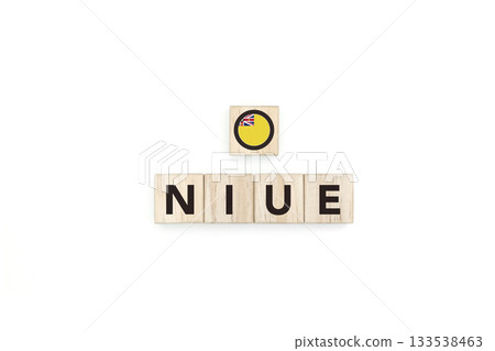 Wooden blocks bearing the name and flag of Niue. Niuean and Micronesian Culture, national identity, travel, and geography in a copy space design. Wooden blocks bearing the name and flag of Niue. Niuean and Micronesian Culture, national identity, travel, and geography in a copy space design. 133538463