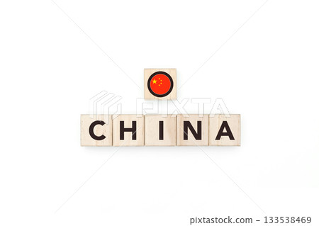 Wooden blocks bearing the name and flag of China. Chinese and Asian Culture, national identity, travel, and geography in a copy space design. Wooden blocks bearing the name and flag of China. Chinese and Asian Culture, national identity, travel, and geography in a copy space design. 133538469