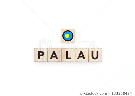 Wooden blocks bearing the name and flag of Palau. Palauan and Micronesian Culture, national identity, travel, and geography in a copy space design. 133538484