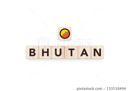 Wooden blocks bearing the name and flag of Bhutan. Bhutanese and Asian Culture, national identity, travel, and geography in a copy space design. 133538494